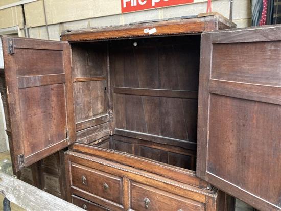 An 18th century panelled oak hanging cupboard, width 130cm, depth 64cm, height 180cm